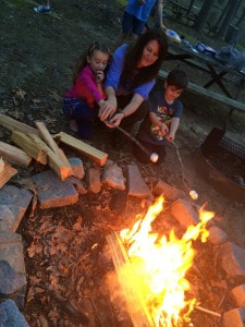 marshmallows on sticks over a fire