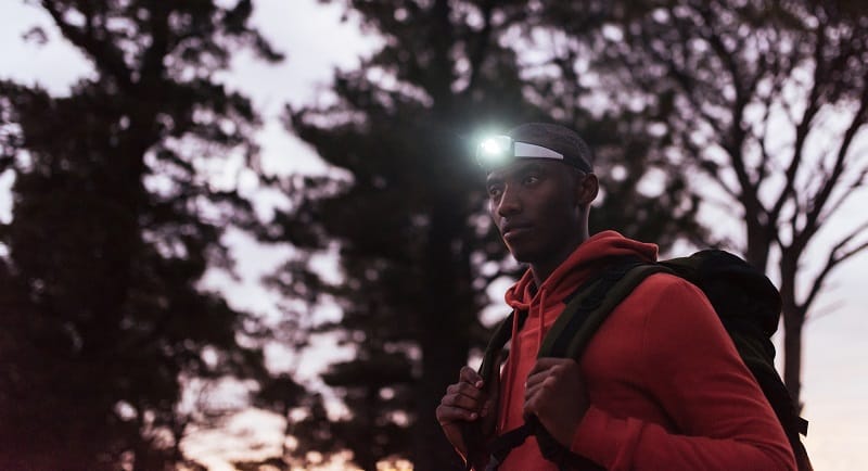 man wearing a headlamp at dusk