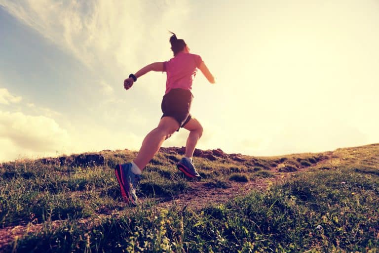 healthy young woman trail runner running