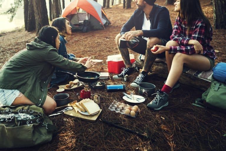 camping friends eating