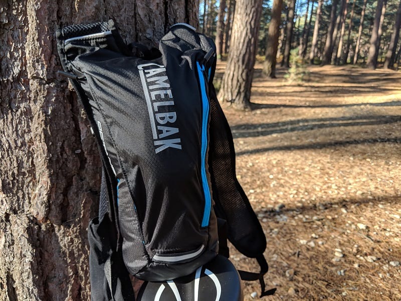 Camelbak octane dart next to tree
